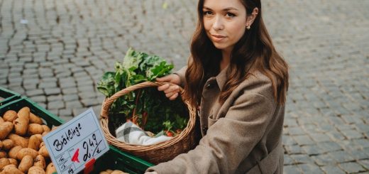 Young woman shopping at Erfurt farmers market, holding basket with fresh vegetables. Capturing local shopping culture.